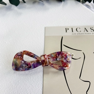 Detail of elegant acetate hair clip with colorful marble texture and metal spring clasp