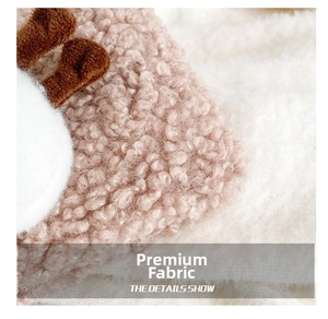 Detail show of soft pink lamb wool fabric texture with plush decorative accents