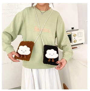 Detail view of plush brown and black shoulder bags with cute 3D cartoon cloud designs