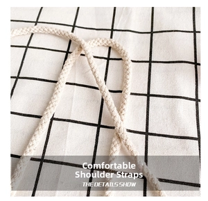 Detail of cream white braided cotton strap with cross-weave texture for kids bag