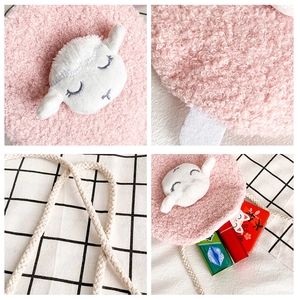 Macro details of pink plush sheep crossbody bag showing soft fleece and braided strap