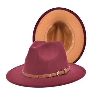 Detail view of two-tone wool fedora hat in burgundy and camel with rivet leather band