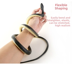 Flexible realistic toy snake with black scales shown wrapping around an arm for prank use