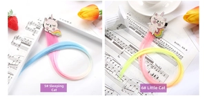 Detail of colorful unicorn hair clips with glitter cat ears and gradient synthetic hair