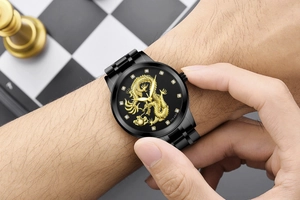 Detail of quartz watch featuring a gold dragon relief on black dial with crystal markers