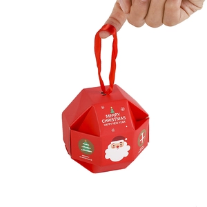 Red Christmas paper candy gift box with silk handle and festive holiday patterns