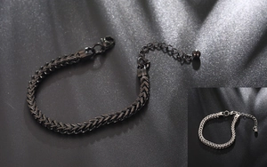 Detail of square-linked wheat chain bracelets in black and silver stainless steel finishes