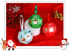 Close-up of festive polyhedron Christmas candy gift boxes in red, green, and light blue colors