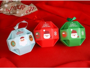 Creative Christmas candy boxes in red, blue, and green with festive Santa patterns