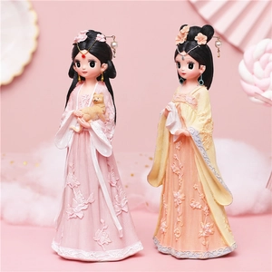 Cute ancient style girl figurines in pink and yellow outfits with cat and fan accessories