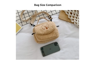Close-up of beige faux shearling crossbody bag with bear embroidery and phone size scale