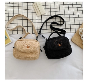 Flat lay of beige and black plush lamb wool crossbody bags with cute bear embroidery