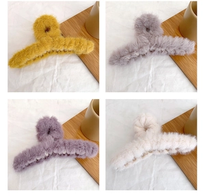 Close-up of plush faux fur hair claws in yellow, grey, purple, and cream white colors