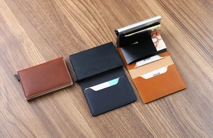Slim RFID blocking wallet showing the pop-up card mechanism and cash compartment