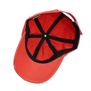 Detail of red vintage baseball cap showing 100% cotton label and internal structure