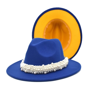 Detail of blue wool felt fedora featuring contrast yellow lining and pearl trim decoration