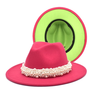 Detail of fuchsia wool fedora with neon green lining and multi-layer pearl chain decor