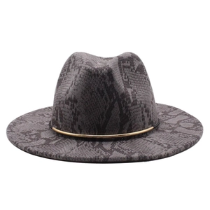 Detail of wide brim fedora hat featuring grey snake print and a thin gold metal band