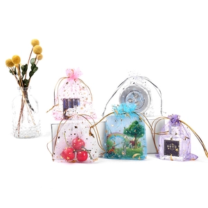 Organza drawstring gift bags with gold stars in pink, white, blue and purple colors