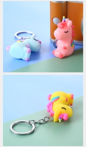 Macro detail of cute PVC unicorn keychains in pink, blue and yellow with metal rings
