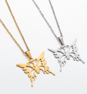 Detailed view of gold and silver butterfly pendant necklaces in stainless steel