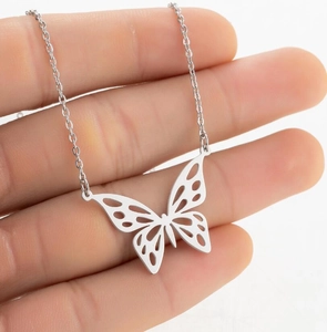 Close-up of a silver hollow butterfly pendant on a delicate stainless steel chain