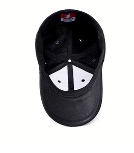 Detail view of the black baseball cap showing the breathable mesh and 100% polyester tag