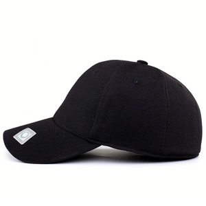 Black fitted baseball cap with six-panel structure and silver label on a curved brim