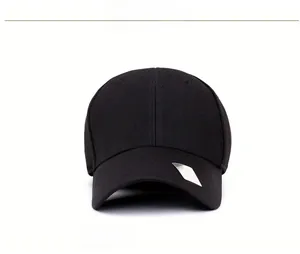Detailed view of black knitted baseball cap with textured pineapple fabric and silver logo
