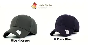 Detail view of dark green and navy blue baseball caps with square silver logo plaques