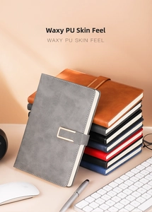 Close-up of assorted A5 PU leather notebooks with textured covers and metal buckles