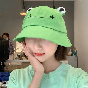 Detailed view of the green frog bucket hat featuring 3D eyes and embroidered mouth detail