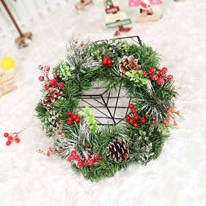 Artificial Christmas wreath with pine needles, cones, and red berries for home decor