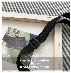 Close-up of adjustable black nylon woven shoulder strap with matte buckle on bag