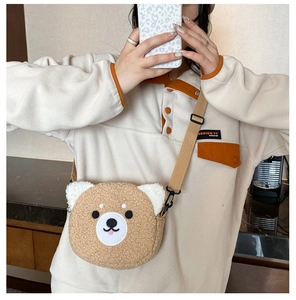 Detail of cute brown plush teddy bear crossbody bag with adjustable nylon shoulder strap