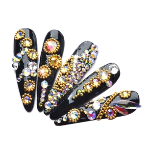 Luxury long pointed black false nails with gold beads and sparkling teardrop rhinestones