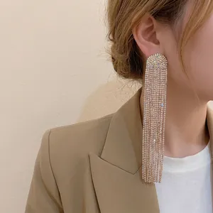 Sparkling long tassel rhinestone earrings with silver needle on model in khaki blazer
