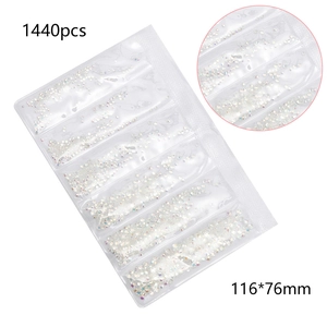 Flat lay of 1440pcs crystal nail art rhinestones in a 6-compartment blister pack