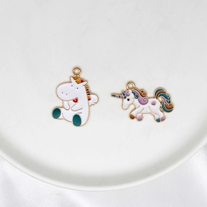 DIY colorful enamel unicorn charms with gold loops on white silk background