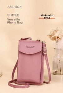 Detailed view of a pink faux leather vertical crossbody phone bag with adjustable strap