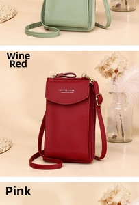 Vertical burgundy faux leather phone bag with Forever Young text and gold hardware
