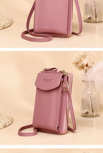 Close-up of pink crossbody phone bag with Forever Young text and gold zipper detail