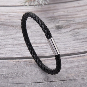 Detail of men's braided black leather bracelet with silver stainless steel magnetic clasp