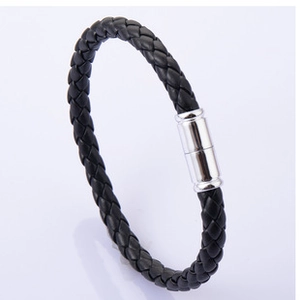 Close-up of black braided leather bracelet with silver magnetic metal clasp for men
