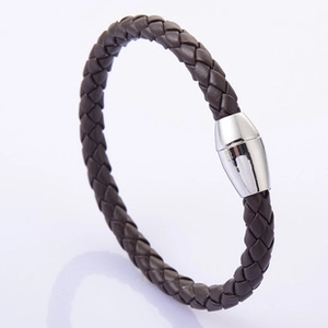 Macro view of dark brown woven leather bracelet with polished silver magnetic clasp