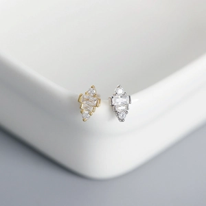 Macro shot of geometric S925 sterling silver earrings with inlaid clear square zircons