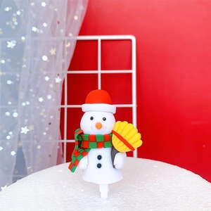 Christmas snowman cake topper with red hat and scarf on a festive red background
