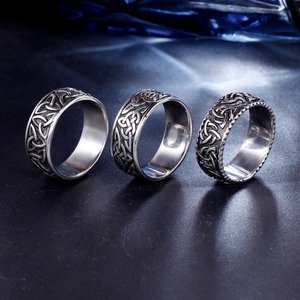 Detailed macro view of three vintage stainless steel rings with Celtic knot patterns