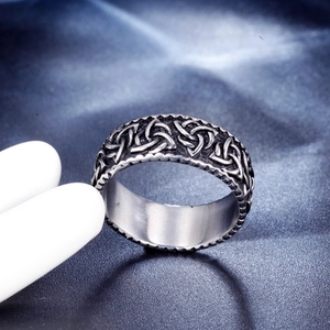 Macro view of vintage silver stainless steel wide ring with Celtic knot relief pattern