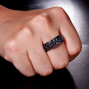 Close-up of vintage Celtic knot patterned stainless steel ring on male model hand